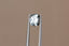 A natural cushion cut steely gray spinel available to add as a center stone for your heirloom setting at The North Way Studio. A steely blueish gray reminiscent of a stormy day. The spinel is shown held up by tweezers.