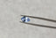 A periwinkle blue shield cut sapphire with light blue zoning