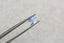 A 2.03 carat silky pale blue opalescent radiant cut sapphire