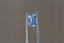 A glowing, faintly opalescent shade of light to medium blue emerald cut sapphire. This Sri Lankan sapphire is available for purchase alongside an heirloom setting at The North Way Studio. The sapphire is shown held up by tweezers.