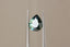 A natural pear cut blue green sapphire available to add as a center stone for your heirloom setting at The North Way Studio. A mesmerizing sapphire pool of greens and blues. The stone is shown held up by tweezers with light reflecting off of its face.