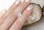 An ethereal pale blue and hazy white opalescent hexagon sapphire on a hand