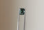 A natural emerald cut teal sapphire available to add as a center stone for your heirloom setting at The North Way Studio. A deeper forest teal hue. The sapphire is shown held up with tweezers.