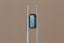 A natural elongated emerald cut teal Montana sapphire available to add as a center stone for your heirloom setting at The North Way Studio. Wisps of yellow and blue dance within this deep teal sapphire. The stone is shown held up by tweezers.
