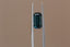 A natural elongated emerald cut teal Montana sapphire available to add as a center stone for your heirloom setting at The North Way Studio. Wisps of yellow and blue dance within this deep teal sapphire. The stone is shown held up by tweezers.