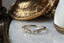 Reverie Diadem band by The North Way Studio featuring a crown of curved baroque leaves unfurling into a thin taper, encrusted with six petite white diamonds. Crafted in your choice of reclaimed 14 or 18 karat gold, this ring evokes the elegance of bygone eras with a delicate 'V' contour design. Shown facing the viewer.