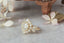 Antique inspired flower engagement ring. Natural diamond halo and leaves set around an antique old European cut diamond and cast in reclaimed 18 karat yellow gold.