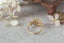 Natural diamond marquise leaves and a graduated diamond halo are set in reclaimed 18 karat yellow gold around an antique old European cut diamond. Ready to ship antique inspired flower engagement ring, size 6.