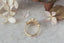 Antique inspired flower engagement ring. Natural diamond halo and leaves set around a warm colored antique diamond in reclaimed 18 karat yellow gold.