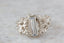 An elongated pale blue sapphire sits within a hand-carved band of white gold in this ring designed by The North Way Studio. The ready to ship engagement ring is shown in a super closeup.