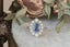 An antique inspired flower engagement ring with a large blue sapphire and natural diamond halo in 18 karat white gold with hand-carved leaves and bark texture. A ready to ship ring crafted by The North Way Studio in collaboration with Claire Pettibone.