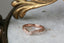 Contoured engraved wedding band with three diamonds.