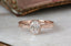 An antique inspired engraved engagement ring setting, customizable with choice of reclaimed fine gold and center jewel. Shown in 14 karat rose gold with lab grown oval diamond.