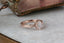 An antique inspired engraved engagement ring setting, customizable with choice of reclaimed fine gold and center jewel. Shown in 14 karat rose gold with lab grown oval diamond.