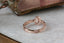 An antique inspired engraved engagement ring setting, customizable with choice of reclaimed fine gold and center jewel. Shown in 14 karat rose gold with lab grown oval diamond.