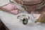This forest fae engagement ring features a dark forest green natural oval brilliant cut sapphire, two marquise diamonds, and a rustling of leaves and bark texture hand-carved into reclaimed 18 karat white gold. This elven fairytale garden engagement ring is ready to ship, size 6 1/2. Crafted by The North Way Studio in collaboration with Claire Pettibone.