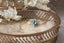 An enchanted garden three stone engagement ring in natural Montana sapphire and diamonds by The North Way Studio and Claire Pettibone. Reclaimed 18 karat yellow gold hand carved with leaves and bark texture. A high fantasy engagement ring.