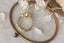 Top view of a hand carved bark and leaf engagement ring with natural diamonds and sapphire by The North Way Studio and Claire Pettibone.