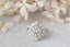 An antique inspired flower diamond halo engagement ring with natural light gray diamond center in white gold.