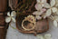 A flower engagement ring featuring a large natural pink spinel, diamond halo, marquise sapphire leaves, and hand carved leaves and bark texture in 18 karat yellow gold. An antique inspired fairy garden engagement ring. Ready to ship, crafted by The North Way Studio in collaboration with Claire Pettibone.
