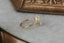 This custom heirloom engagement ring setting designed and crafted by The North Way Studio features delicate leaves carved in reclaimed gold and a cluster of diamond dew drops spun about your choice of center gemstone. This fantasy ring is shown in 14 karat yellow gold with a large pear cut diamond center.