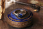 This custom heirloom engagement ring setting designed and crafted by The North Way Studio features delicate leaves carved in reclaimed gold and a cluster of diamond dew drops spun about your choice of center gemstone. This fantasy engagement ring is shown cast in reclaimed 14 karat white gold with a round blue sapphire center stone.