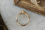 This custom heirloom engagement ring setting designed and crafted by The North Way Studio features delicate leaves carved in reclaimed gold and a cluster of diamond dew drops spun about your choice of center gemstone. This fantasy ring is shown in 14 karat yellow gold with a large pear cut diamond center.