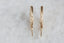 Everyday yellow gold hoop earrings with hand-carved leaves.