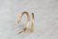 Everyday elven-inspired yellow gold hoop earrings with hand-carved leaves.