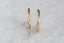 Everyday yellow gold hoop earrings with hand-carved leaves.