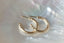 Everyday yellow gold hoop earrings with hand-carved leaves.