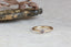 A ready to ship solitaire ring inspired by antique collet settings in 14 karat yellow gold and a natural rose toned Montana sapphire