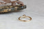 A solitaire ring inspired by antique collet settings in 14 karat yellow gold and natural Montana sapphire