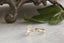A three stone diamond engagement ring in 14 karat yellow gold