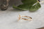 A three stone diamond engagement ring in 14 karat yellow gold
