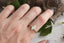 A three stone engagement ring with marquise cut lab grown diamond and natural pear cut diamonds