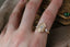 Ready to ship fantasy three stone engagement ring in oval brilliant cut lab grown diamonds and reclaimed 14 karat yellow gold by The North Way Studio. Size 6 1/2. Shown on the hand.