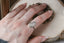 A solitaire fantasy engagement ring crafted by The North Way Studio. This fairytale ring features a lab grown marquise diamond, an engraved shield setting, and organic carvings in the gold on one side. Shown in 14 karat white gold worn on a left hand.