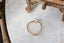 Antique style collet setting engagement ring in brushed yellow gold and opalescent diamond.