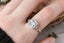 Fantasy elven alternative engagement ring designed and crafted by The North Way Studio. This ready to ship fairytale engagement ring features a diamond halo, a blue princess cut sapphire center, and hand-carved leaves and vines in reclaimed 18 karat white gold.