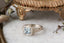 Fantasy fairycore alternative engagement ring designed and crafted by The North Way Studio. This ready to ship elf inspired engagement ring features a diamond halo, a blue princess cut sapphire center, and hand-carved leaves and vines in reclaimed 18 karat white gold.