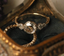 Our Will-O-Wisp ring rests in a beautiful golden jewelry box.