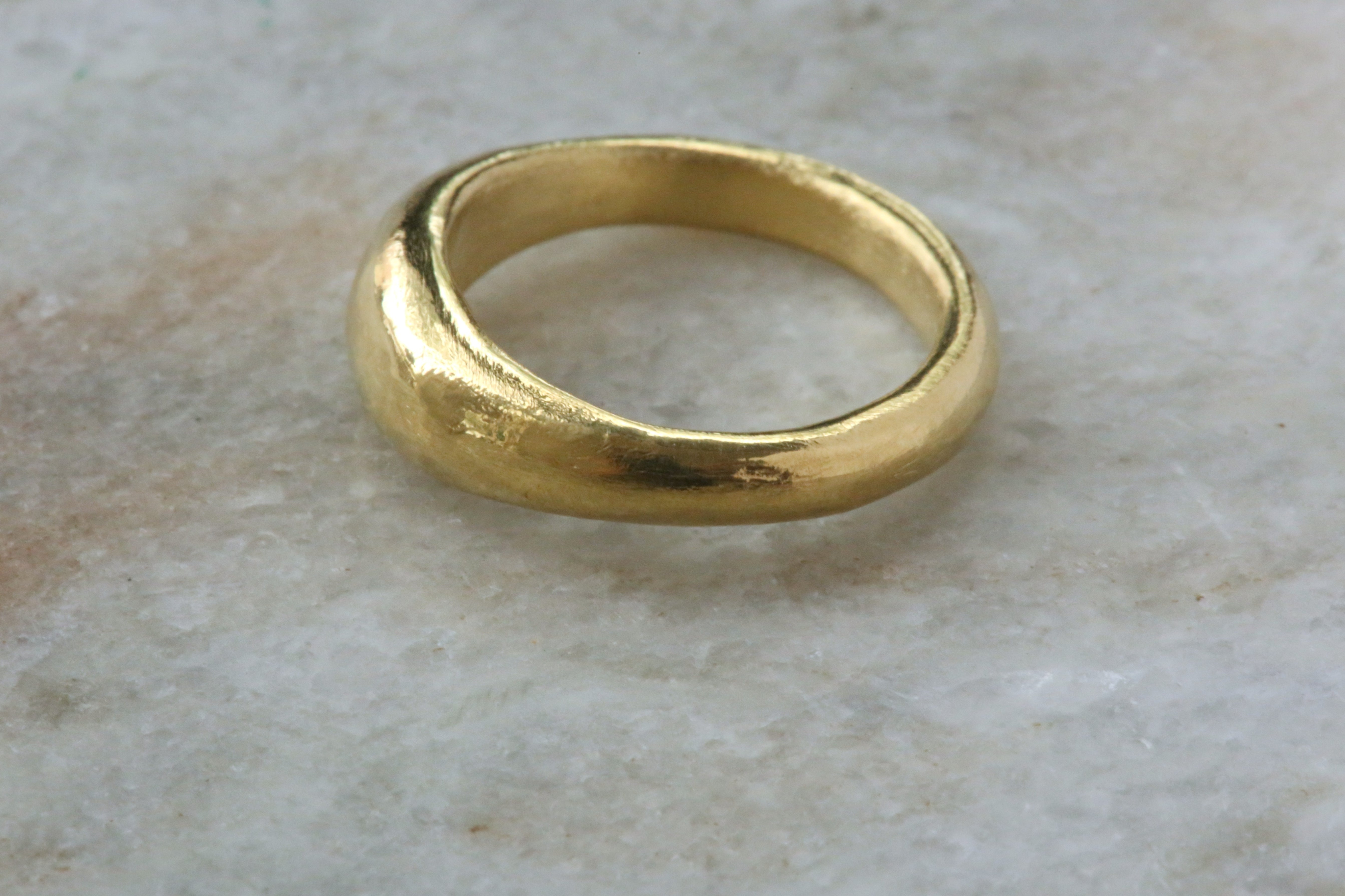 An 18 karat yellow gold signet ring meant to resemble ancient jewelry 