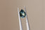 A natural pear cut blue green sapphire available to add as a center stone for your heirloom setting at The North Way Studio. A mesmerizing sapphire pool of greens and blues. The stone is shown held up by tweezers.