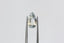 An ethereal blend of pale yellow and soft silvery blue hues in a modified pear cut sapphire.  This 2.59 carats Sri Lankan sapphire is available for purchase alongside an heirloom setting at The North Way Studio. The sapphire is shown held up by tweezers.