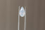 A large pear cut sapphire in silky pale dusky blue with hints of peach opalescence