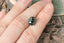 A natural multi-colored cushion cut sapphire with gorgeous hues of teal, green, faint ochre, and a hint of burgundy brown. This 4.12 carat color changing sapphire is available to add to a custom heirloom setting at The North Way Studio.