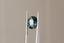 A natural multi-colored cushion cut sapphire with gorgeous hues of teal, green, faint ochre, and a hint of burgundy brown. This 4.12 carat color shifting sapphire is available to add to a custom heirloom setting at The North Way Studio.