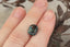 A natural multi-colored cushion cut sapphire with gorgeous hues of teal, green, faint ochre, and a hint of burgundy brown. This 4.12 carat color changing sapphire is available to add to a custom heirloom setting at The North Way Studio.