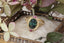 Petite sapphires of mismatched blush and berry tones are woven about a lush teal green sapphire, cocooned in rustic whittled gold in this ring designed by The North Way Studio in collaboration with Claire Pettibone.